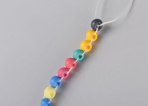 closeup of the top of the column of multicolored seed beads